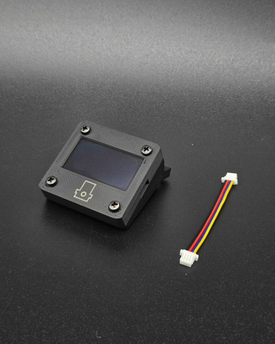 OLED display in a black printed enclosure with a marked Pioreactor logo and attached cable.